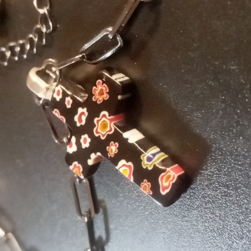 Black Murano Glass Floral Glass Cross Pendant Necklace On Blackened Paper clip.